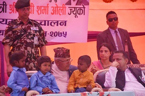 Prime Minister KP Sharma Oli talking to children after they were admitted in Ramdulari Secondary School under the enrolment campaign in Kalyanpur Municipality, Siraha, on Wednesday, April 18, 2018. Photo: THT