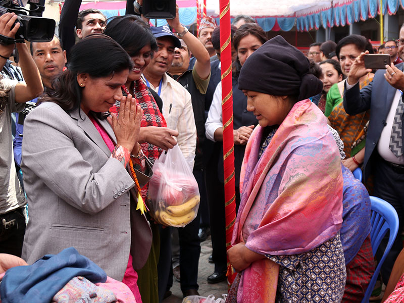 Minister of State for Health, Padma Kumari Aryal, honouring a new mother at the premises of Nursing College of Tribhuvan University Teaching Hospital, on the occasion of Safe Motherhood Day 2075, in Maharajgung, Kathmandu, on Monday, April 16, 2018. Photo: RSS