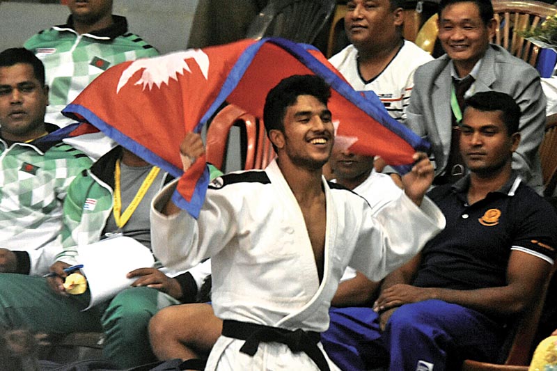 Nepal's Indra Bahadur Shrestha celebrates after winning the men's below 66 kg weight category during the eight South Asian Judo Championship in Lalitpur on Sunday. Photo: Naresh Shrestha/ THT
