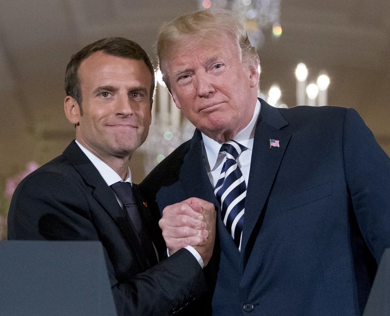 President Donald Trump and French President Emmanuel Macron embrace at the conclusion of a news conference in the East Room of the White House in Washington, on Tuesday, April 24, 2018. Photo: APn