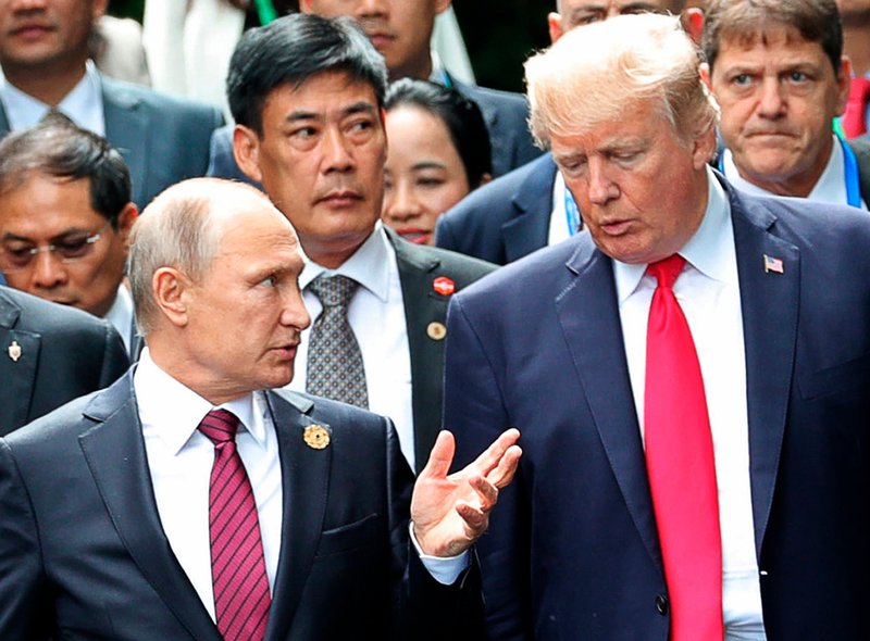 File -  In this file photo, President Donald Trump, right, and Russia President Vladimir Putin talk during the family photo session at the APEC Summit in Danang on Nov. 11, 2017. Photo: AP