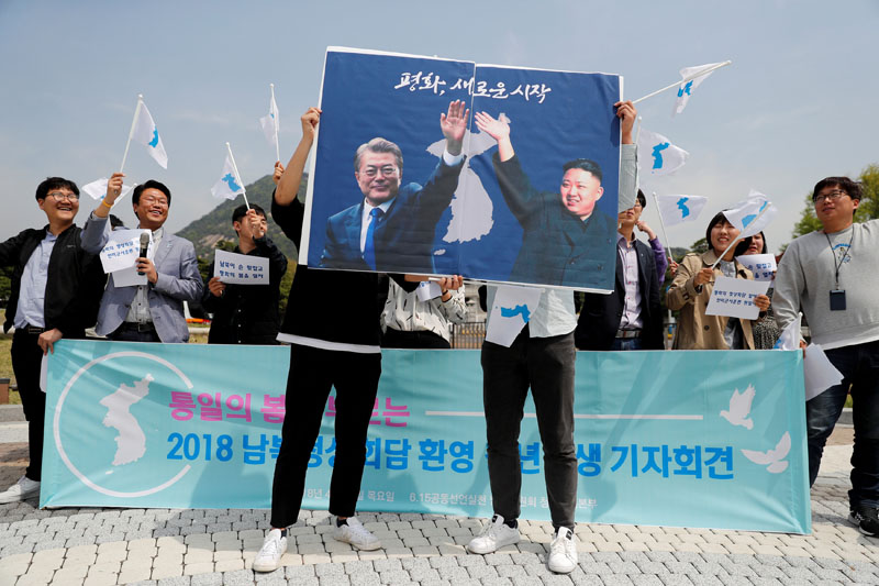 Students hold posters with pictures of South Korea's President Moon Jae-in and North Korea's leader Kim Jong Un during a pro-unification rally ahead of the upcoming summit between North and South Korea in Seoul, South Korea, on April 26, 2018. Photo: Reuters