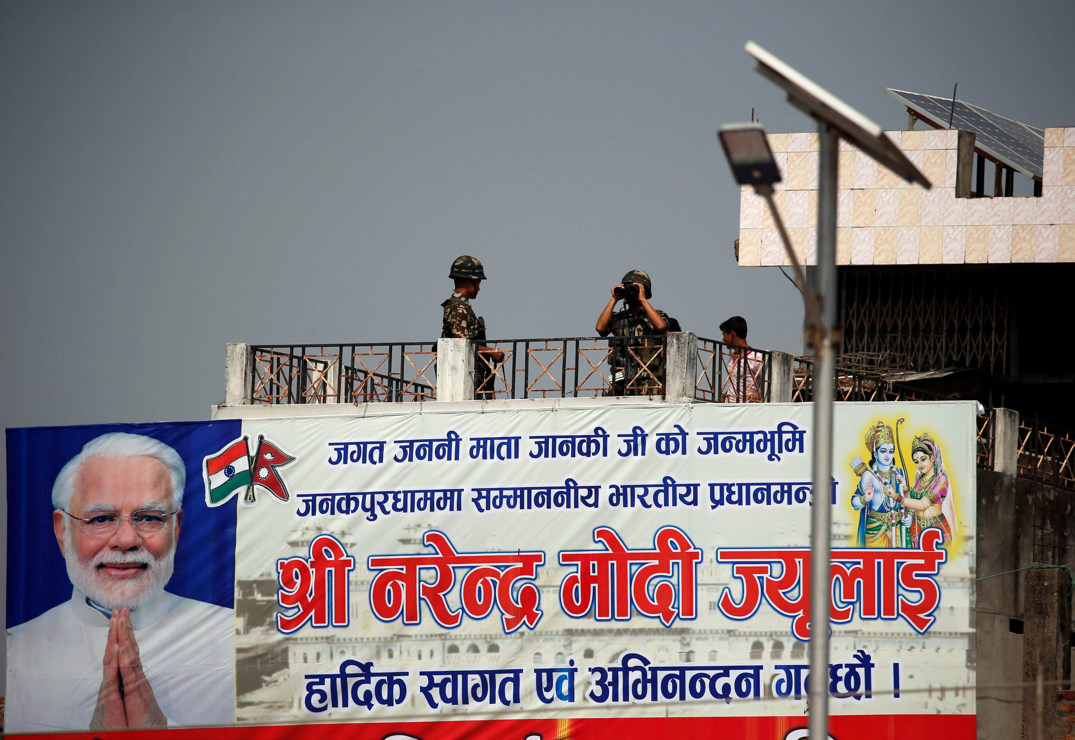 An army member looks through binoculars as he guards the Janaki Mandir, a Hindu temple dedicated to goddess Sita, where India's Prime Minister Narendra Modi is scheduled to visit tomorrow, in Janakpur, Nepal May 10, 2018. PHOTO: REUTERS