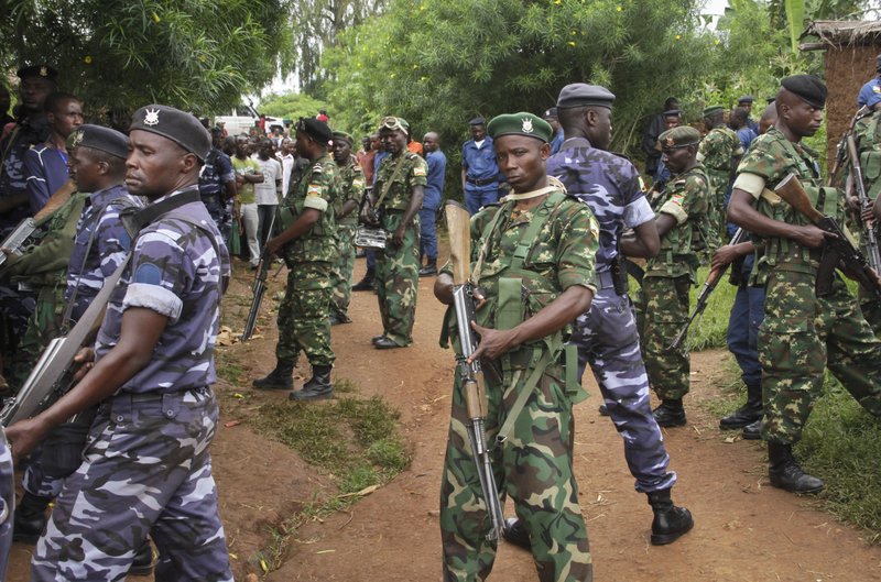 Army soldiers and policemen attend the scene where more than 20 people were killed in their homes in an overnight attack in the Ruhagarika community of the rural northwestern province of Cibitoke, in Burundi on Saturday, May 12, 2018. Photo: AP