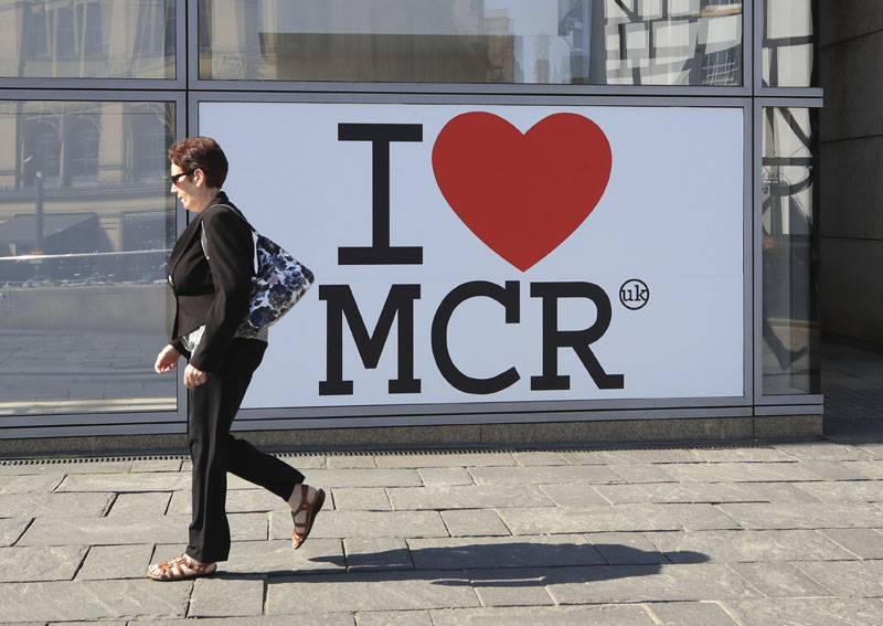 A woman walks past a 'I Love Manchester' sign ahead of the Manchester Arena National Service of Commemoration at Manchester Cathedral, to mark one year since the attack on Manchester Arena, on Tuesday May 22, 2018. Photo: Associated Press