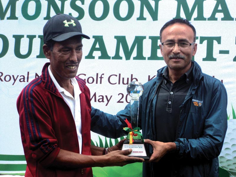 RNGC President Rabindra Man Shrestha handing over the trophy to Hari Thapa (left) after the Monsoon Mania Golf Tournament in Kathmandu on Saturday, May 5, 2018. Photo: THT