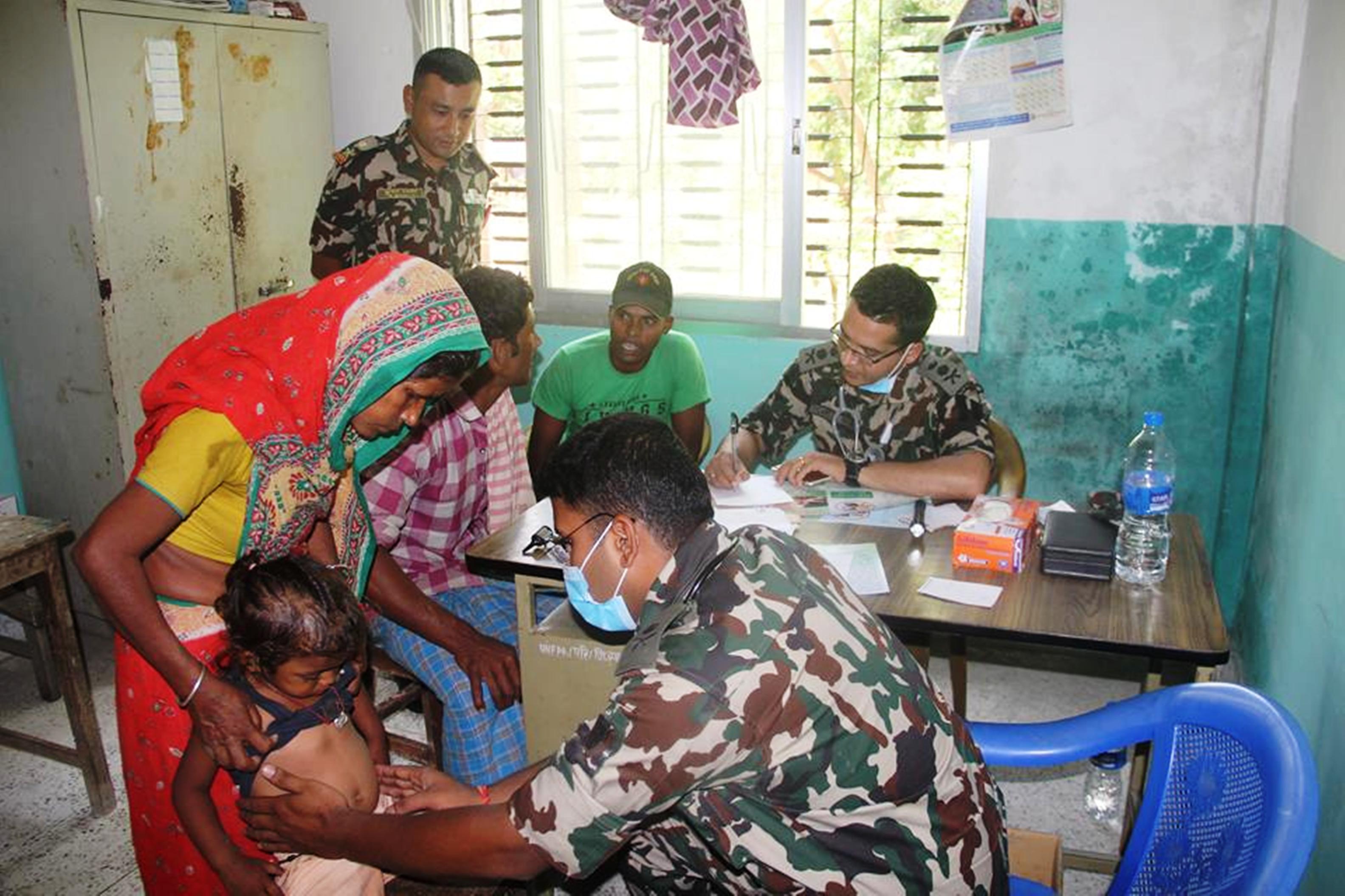 Doctors examining denizens of Dumriya in Ishanath Municipality, Rautahat at a free health camp ran by Nepal Armyu2019s Indra Box Battalion on Wednesday, May 9, 2018. Photo: Prabhat Kumar Jhan