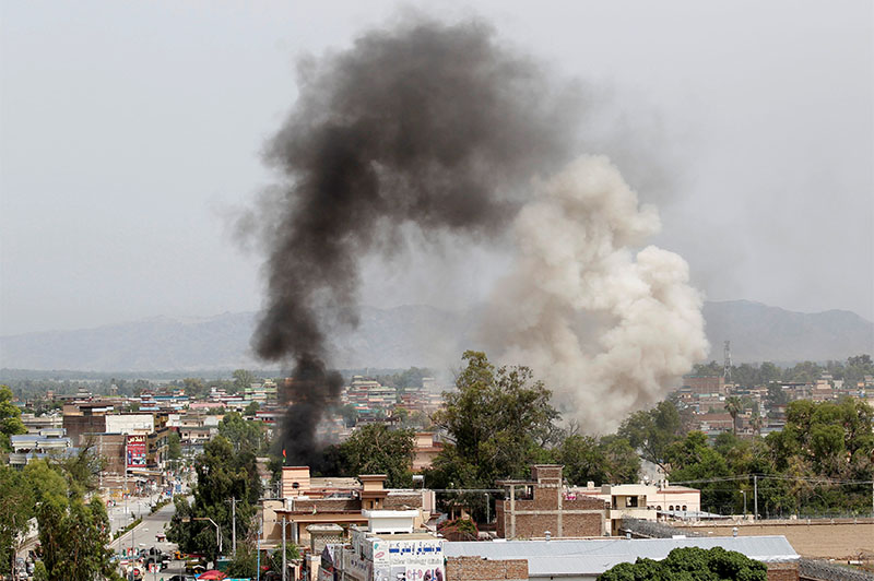 Smoke rises from the site of a blast and gunbattle between Afghan security forces and a handful of militants in Jalalabad city, Afghanistan May 13, 2018. Photo: Reuters