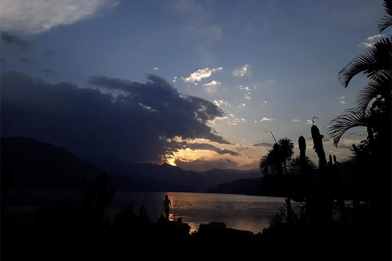A silhouette of a man is seen against the backdrop of  dimming sky above Phewa Lake, in Pokhara, on Thursday, May 11, 2018. Photo: Sandeep Sen