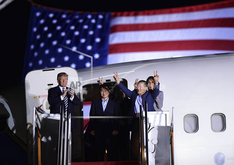 President Donald Trump, from left, greets Tony Kim, Kim Hak Song, seen in the shadow, and Kim Dong Chul, three Americans detained in North Korea for more than a year, as they arrive at Andrews Air Force Base in Md., Thursday, May 10, 2018. First lady Melania Trump also greet them at right. (AP Photo/Susan Walsh)