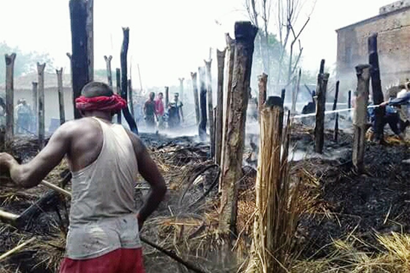 A local man along with fire fighters trying to douse fire at Jayamangalapur in Chiparmai Rural Municipality-3 in Parsa district, on Thursday, May 03, 2018. Photo: Ram Sarraf