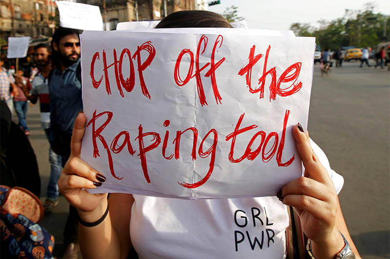 FILE PHOTO: A woman holds a placard during a protest against the rape of an eight-year-old girl in Kathua near Jammu, and a teenager in Unnao, Uttar Pradesh state, in Kolkata, India, April 19, 2018. Photo: Reuters