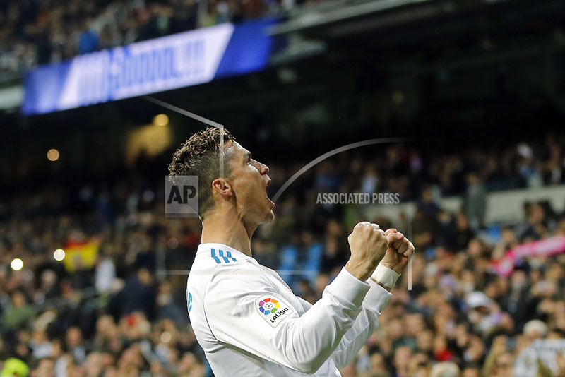 FILE - In this Sunday, March 18, 2018 file photo, Real Madrid's Cristiano Ronaldo celebrates after scoring his second goal during a Spanish La Liga soccer match between Real Madrid and Girona at the Santiago Bernabeu stadium in Madrid, Spain. Ronaldo will be the star in Madridu0092s likely 4-3-3 formation, during the Champions League soccer final against Liverpool on Saturday, May 26, 2018.  (AP Photo/Paul White, File)
