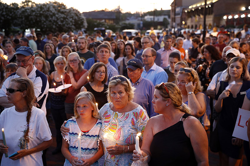 Mourners stand in silence during a vigil in response to a shooting at the Capital Gazette newsroom, in Annapolis, Maryland, on Friday, June 29, 2018. Prosecutors say 38-year-old Jarrod W Ramos opened fire Thursday in the newsroom. Photo: AP
