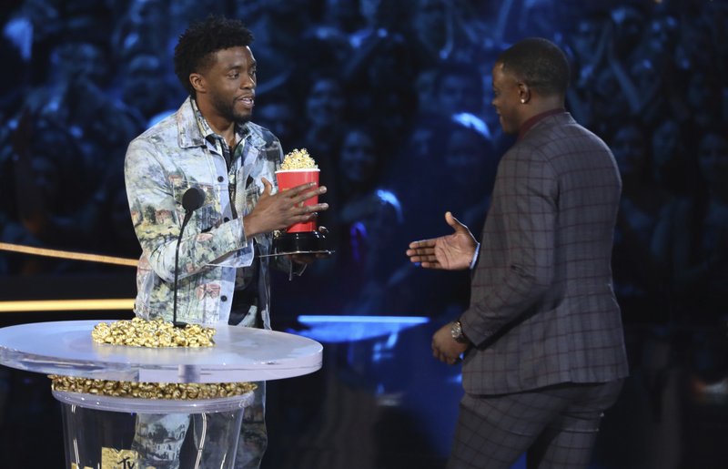 In this photo, Chadwick Boseman, left, gives his best hero award for his role in u201cBlack Pantheru201d to James Shaw Jr., who is credited with saving lives during a shooting at a Waffle House in Antioch, Tenn., at the MTV Movie and TV Awards at the Barker Hangar in Santa Monica, Calif on Saturday, June 16, 2018. Photo: APn