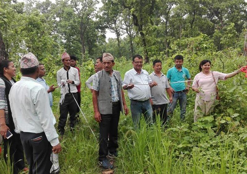 Technicians, local representatives and locals measuring the land for construction of  a park, in Bharatpur Metropolitan City, on Tuesday, June 19, 2018. Photo: THT