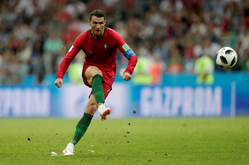 Soccer Football - World Cup -    Portugal's Cristiano Ronaldo scores their third goal from a free kick to complete his hat-trick  against Spain in Group B match of 2018 Football Fifa World Cup in Fisht Stadium, Sochi, Russia, on June 15, 2018. Photo: Reuters