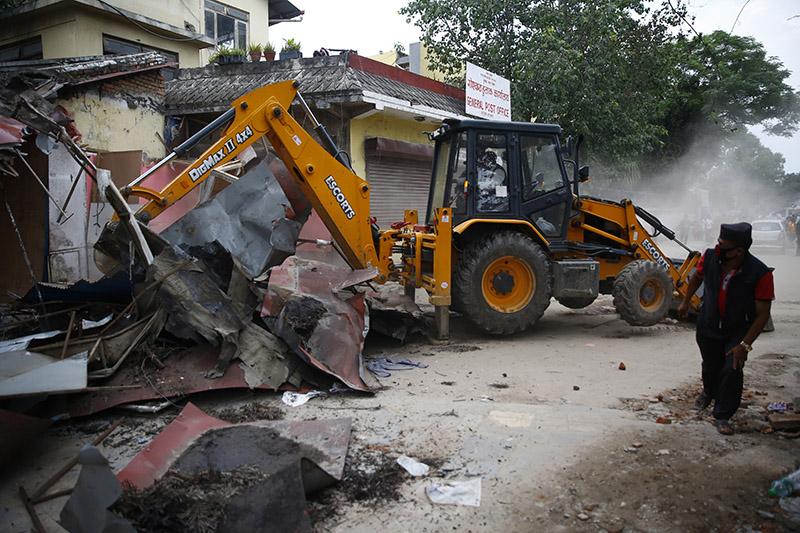 A dozer being used to demolish illegal structures for the construction of a new Dharahara tower, in Kathmandu, on Saturday. Photo: THT