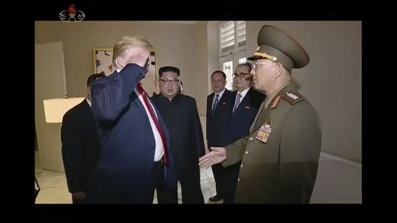In this image made from, video released by KRT, U.S. President Donald Trump salutes No Kwang Chol, minister of the Peopleu2019s Armed Forces of North Korea, as North Korean leader Kim Jong Un, center, introduces Trump to the general during the summit in Singapore on June 12, 2018. Photo: APn