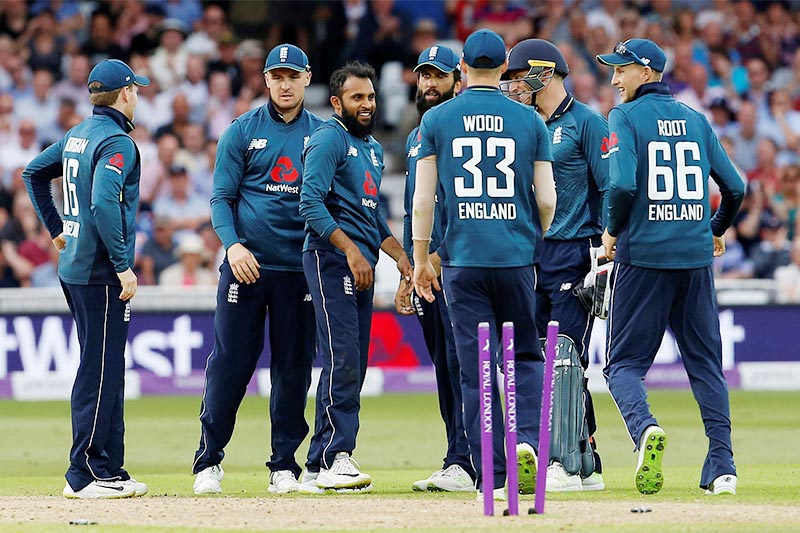 England's Adil Rashid celebrates with team mates after taking the wicket of Australia's Aaron Finch. Photo: Reuters