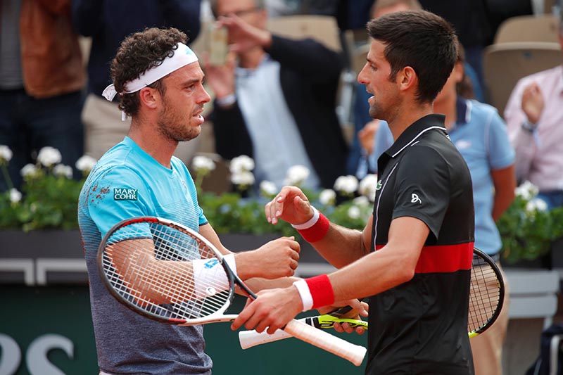 Italy's Marco Cecchinato shakes hands with Serbia's Novak Djokovic after winning their quarter final match during the French Open, in Paris, France, on June 5, 2018. Photo: Reuters