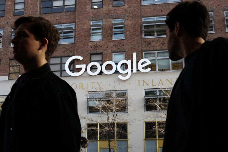 File - In this photo, people walk by Google offices in New York on Dec. 4, 2017. Photo: AP