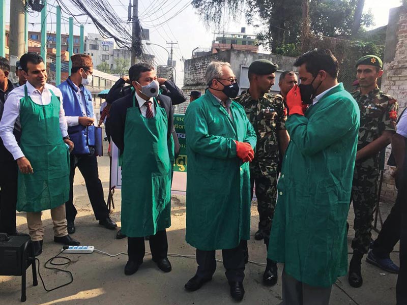 Minister of Home Affairs Ram Bahadur Thapa and Minister of Forest and Environment Shakti Bahadur Basnet standing on a road to conduct emissions test of vehicles, in Kathmandu, on Sunday, June 3, 2018. Photo: THT