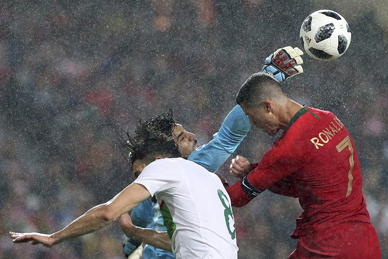Algeria goalkeeper Abdelkaadir Salhi, makes to save headshot of Portugal's Cristiano Ronaldo during a friendly soccer match between Portugal and Algeria in Lisbon, Portugal, on Thursday, June 7, 2018. Photo: AP