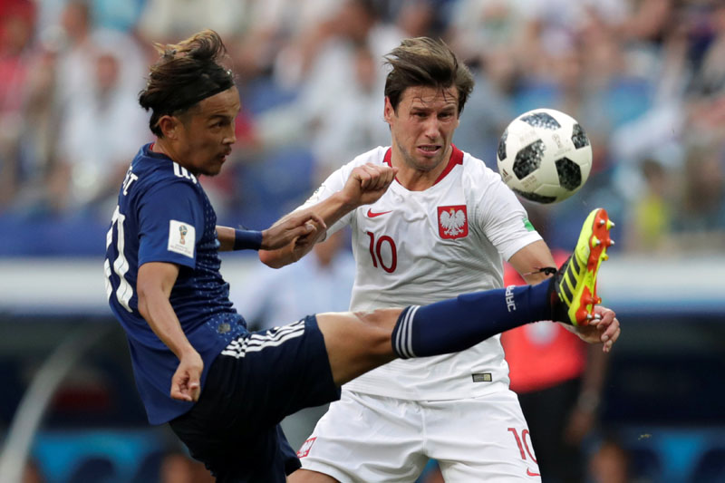 Soccer Football - World Cup - Group H - Japan vs Poland - Volgograd Arena, Volgograd, Russia - June 28, 2018   Japan's Takashi Usami in action with Poland's Grzegorz Krychowiak    REUTERS/Ueslei Marcelino