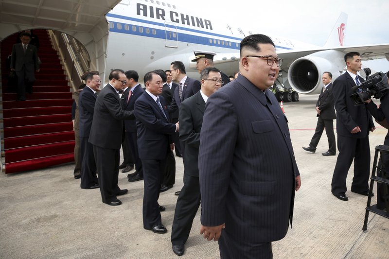 File - In this file photo released by the Ministry of Communications and Information of Singapore, North Korean leader Kim Jong Un, right, arrives at the Changi International Airport on board a Air China flight in Singapore ahead of a summit with U.S. President Donald Trump on June 10, 2018. Photo: AP