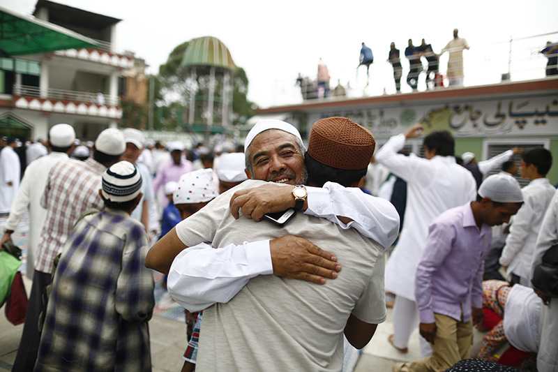 Nepali Muslims embrace each other after offering prayers during Eid al-Fitr festival at Jame Mosque, in Kathmandu, on Saturday, June 16, 2018. Photo: Skanda Gautam