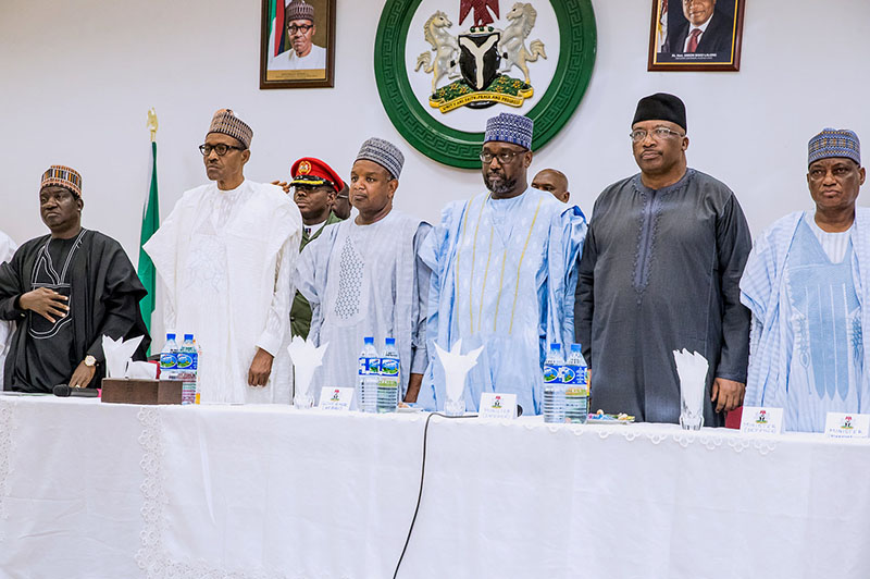 Nigeria's President Muhammadu Buhari stands with Plateau State Governor Simon Lalong and officials during his visit to Plateau State, Nigeria in this handout picture released on June 26, 2018. Photo Courtesy: Nigeria Presidency/Handout via Reuters