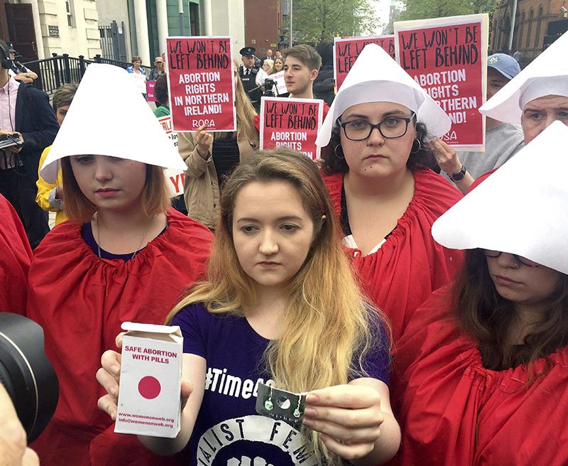 Eleanor Crossey Malone (centre), from the socialist feminist group Rosa, after claiming to have taken an abortion pill during a demonstration outside Belfast's Crown and High Courts, Northern Ireland Thursday May 31, 2018. . Photo: AP