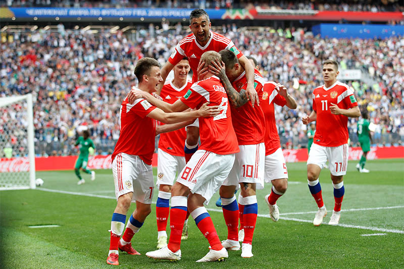 Russia's Yury Gazinsky celebrates scoring their first goal with team mates. Photo: Reuters