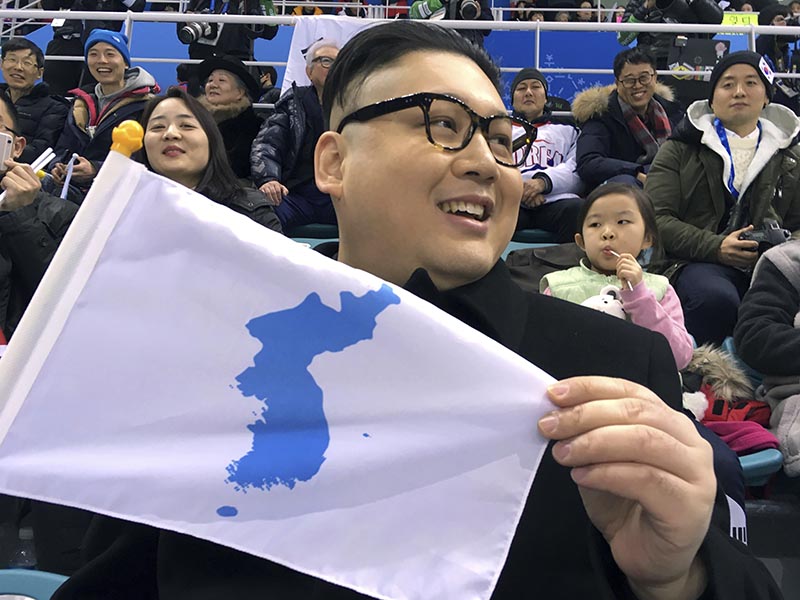 FILE - A Kim Jong Un impersonator, calling himself only Howard X from Australia, holds a unification flag while attending the Korea-Japan women's ice hockey game at the 2018 Winter Olympics in Pyeongchang, South Korea, on February 14, 2018. Photo: AP