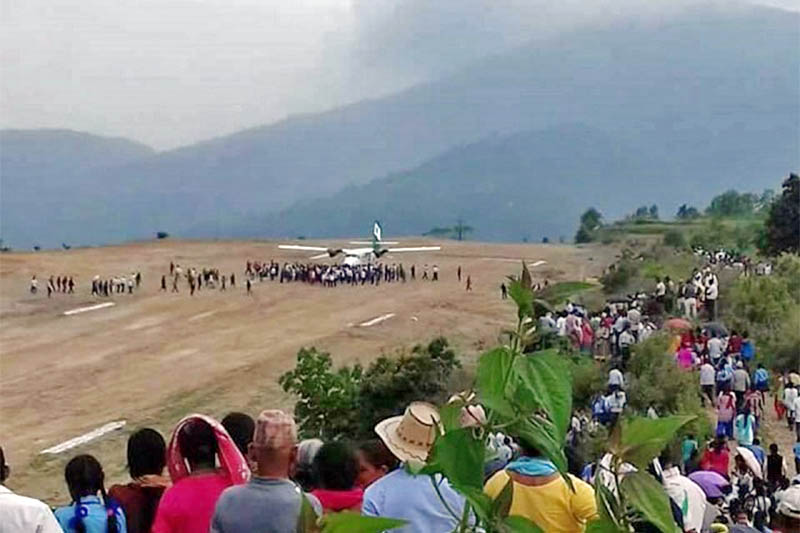 People gather around to observe a plane after it makes first successful landing at Sukilamba Airport in Ilam district, on Monday, June 04, 2018. Photo: Laxmi Gautam