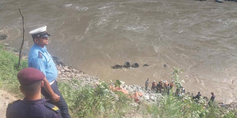 Security personnel inspect the site where a vehicle  plunged into Trishuli river, at Tikrangkhani, Jogimara, in Benighat Rorang Rural Municipality-10, Dhading district, on Saturday, June 9, 2018. Wheels of the truck (Na 5 Kha 3415) appears above the murky water. Photo: Keshav Adhikari