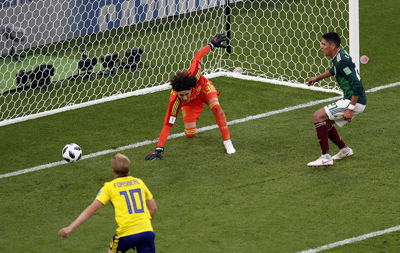 Mexico's Edson Alvarez (right), scores an own goal past his goalkeeper during the group F match between Mexico and Sweden, at the 2018 soccer World Cup in the Yekaterinburg Arena in Yekaterinburg , Russia, Wednesday, June 27, 2018. Photo: AP