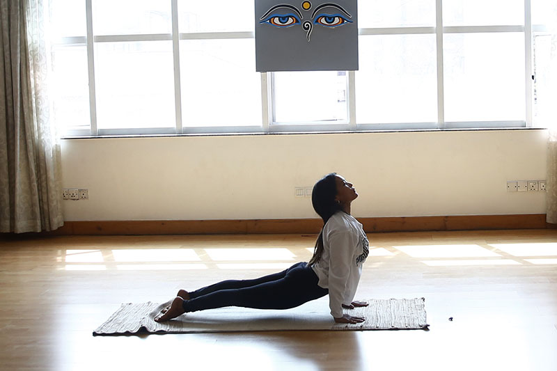 A Nepali woman performs yoga during the International Day of Yoga, in Kathmandu, on Thursday, June 21, 2018. Photo: Skanda Gautam/THT