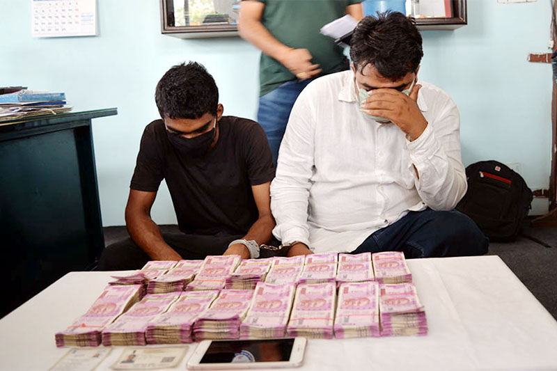 Arrestees along with seized demonetised Indian banknotes being made public at the Parsa District Police Office in Birgunj, on Wednesday, June 6, 2018. Photo: Ram Sarraf