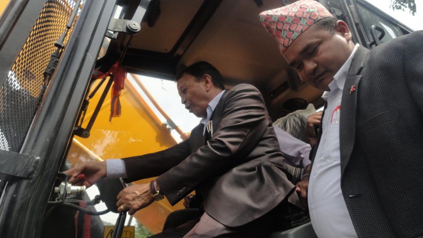 Pokhara Metropolis Mayor Man Bahadur GC pictured at a pedestrian path inauguration programme, moments before mishandling the excavator lever. The Mayor operated an excavator sans technical expertise and  injured five including two journalists while destroying a railing on Friday, June 15, 2018. PHOTO:THT 