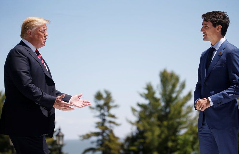 FILE PHOTO: U.S. President Donald Trump approaches Canada's Prime Minister Justin Trudeau as he arrives at the G7 Summit in Charlevoix, Quebec, Canada, June 8, 2018. REUTERS/Leah Millis/File Photo