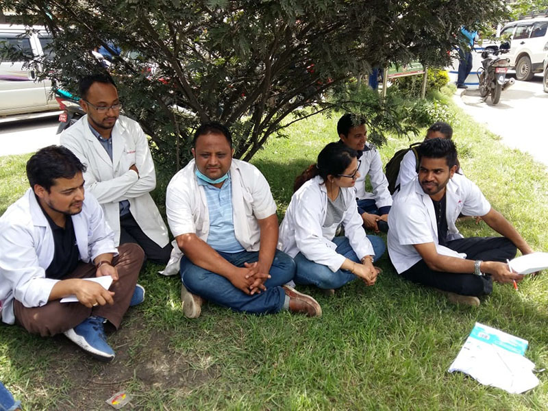Resident doctors of Tribhuvan University Teaching Hospital (TUTH), who halted their service at the hospital, continue their strike in support of Dr Govinda KC, at Maitighar Mandala, in Kathmandu, on Friday, July 13, 2018. Photo: Anita Shrestha/THT