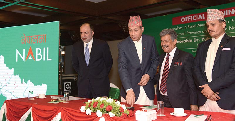 Finance Minister Yubaraj Khatiwada electronically inaugurating 12 new branches of Nabil Bank in remote rural municipalities of mid- and far-west regions of the country, during a programme in Kathmandu, on Tuesday. Photo Courtesy: Nabil Bank