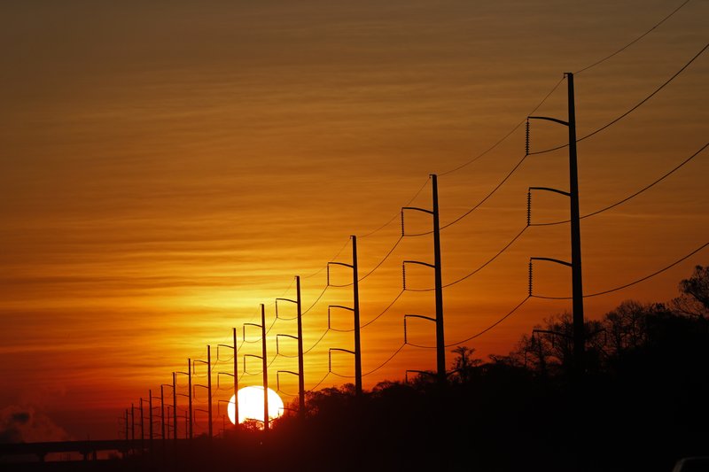 File - In this photo, the sun rises beyond power lines in St. Charles Parish, La on Jan. 31, 2018. Photo: AP