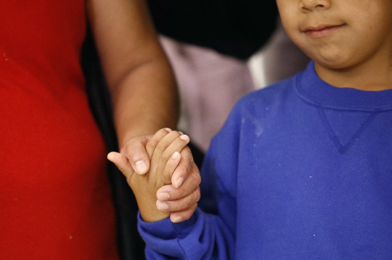 File - In this photo, a mother, left, and son, from Guatemala, hold hands during a news conference following their reunion in Linthicum, Md., after being reunited following their separation at the U.S. border on  Friday, June 22, 2018. Photo: AP