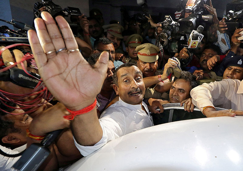 Kuldeep Singh Sengar, a legislator of Uttar Pradesh state from India's ruling Bharatiya Janata Party (BJP), reacts as he leaves a court after he was arrested on Friday in connection with the rape of a teenager, in Lucknow, India, April 14, 2018. Photo: Reuters/ File