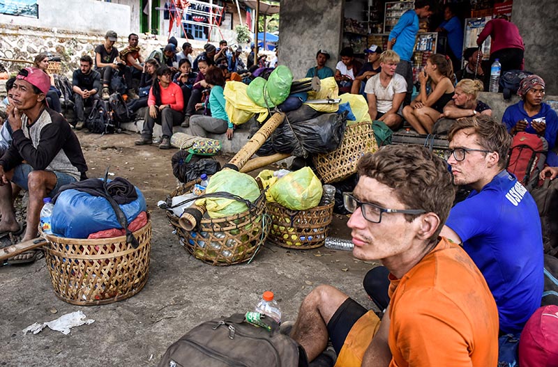 Indonesian and foreign climbers are seen after walking down from Rinjani Mountain at Sembalun village in Lombok Timur, Indonesia, July 29, 2018. Picture taken July 29, 2018. Photo: Antara Foto/Ahmad Subaidi/via Reuters