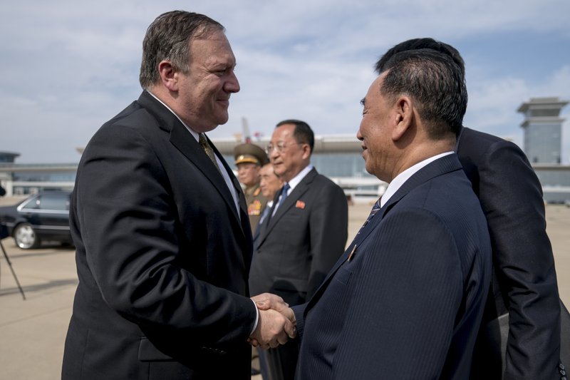 U.S. Secretary of State Mike Pompeo, left, says goodbye to Kim Yong Chol, right, a North Korean senior ruling party official and former intelligence chief, before boarding his plane at Sunan International Airport in Pyongyang, North Korea, on Saturday, July 7, 2018, to travel to Japan. Photo: AP
