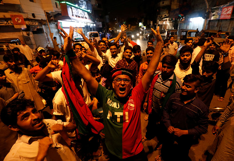 Supporters of Pakistan Tehreek-e-Insaf (PTI) political party celebrate along the road during the general election in Karachi, Pakistan, on July 25, 2018.  Photo: Reuters